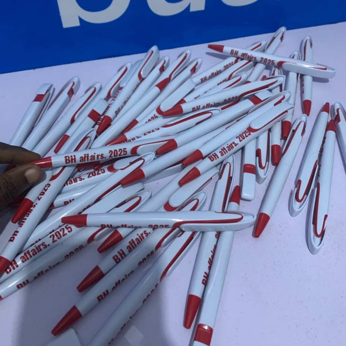 Red and white branded plastic pens